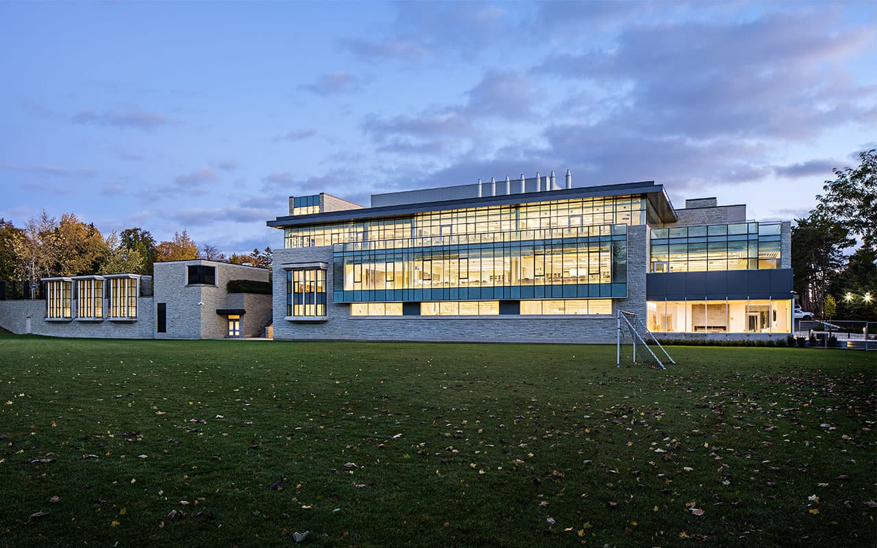 Evening view of the school building across its lawn